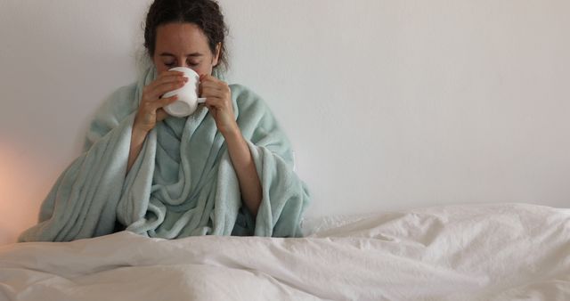 Woman Wrapped in Blanket Drinking Hot Beverage in Bed - Download Free Stock Images Pikwizard.com