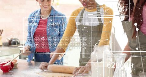 Friends baking together with futuristic data overlay rolling dough and collaborating