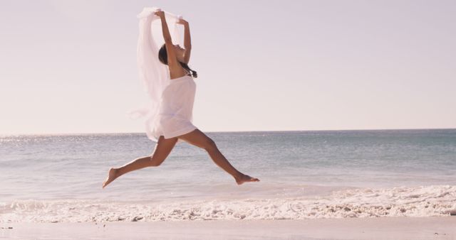 Woman Leaping with Fabric on Sunny Beach - Download Free Stock Images Pikwizard.com