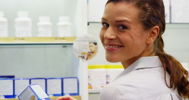 Smiling Female Pharmacist Looking Over Shoulder - Download Free Stock Photos Pikwizard.com