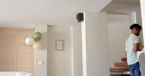 Man decorating home with balloons for celebration