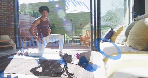 Man practicing yoga and recording fitness routine in modern living space