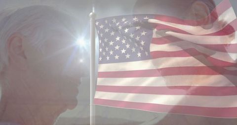 Mature Couple Facing Each Other With American Flag Waving in Between