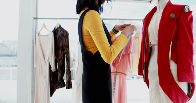 A young woman examines a red jacket in a bright clothing store, with copy space. Her shopping experience highlights the vibrant choices available in modern fashion retail.