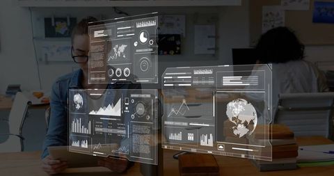 Male analyzing holographic data dashboards with tablet in open-plan coworking office