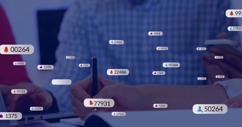 Hands writing during team meeting with mobile devices and social notifications overlay