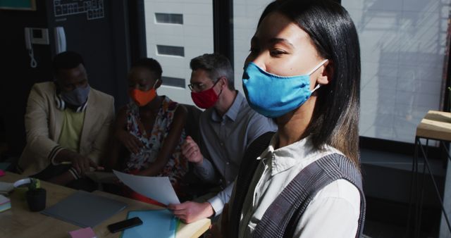 Team brainstorming in office with masks, discussing design projects - Download Free Stock Images Pikwizard.com