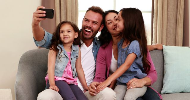 Happy Family of Four Taking Selfie on Sofa - Download Free Stock Images Pikwizard.com