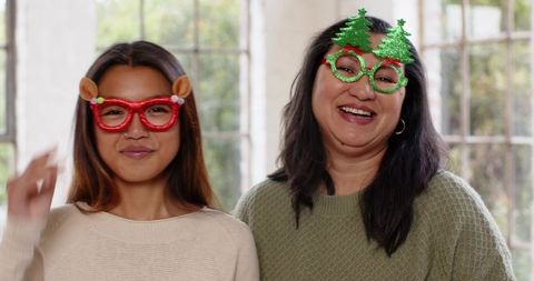 Mother and Daughter Sharing Joyful Moments with Novelty Holiday Glasses