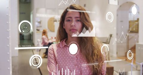 Businesswoman analysing data on transparent virtual screen