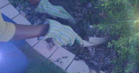 Hands Planting in Garden with Gloves for Eco-Friendly Activity