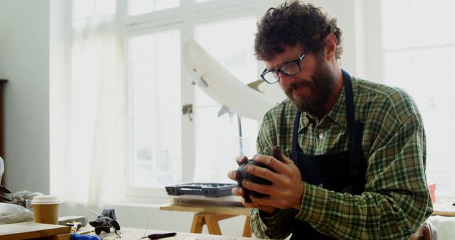 Man Sculpting Clay in Art Studio with Natural Light - Download Free Stock Images Pikwizard.com