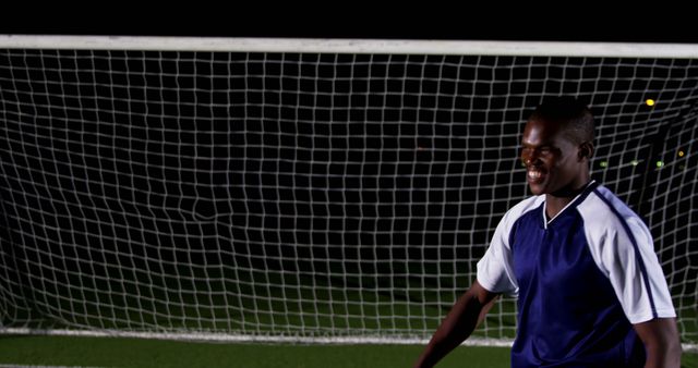 Soccer Player Smiling Near Goal Post at Night - Download Free Stock Images Pikwizard.com