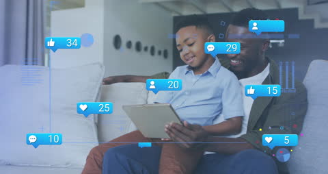 Father and Son Using Tablet with Social Media Interface Overlay