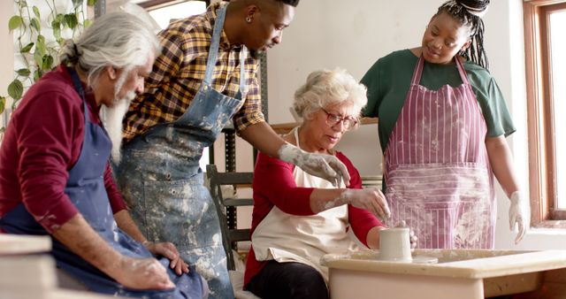 Seniors engaged in a pottery class with a teacher guiding their work. Perfect for showcasing senior activities, creative workshops, and intergenerational learning. Can be used in brochures for community centers, retirement homes, or educational programs focused on art and elder engagement.