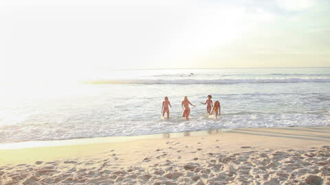 Women Joyfully Emerging from Ocean Waves Together