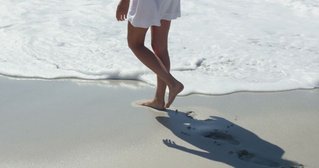 Woman walking on the beach bare footed - Download Free Stock Photos Pikwizard.com