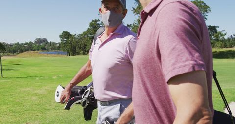 Senior Men Playing Golf with Masks During Pandemic
