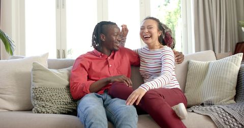 Happy Couple Laughing on Cozy Couch at Home - Download Free Stock Images Pikwizard.com