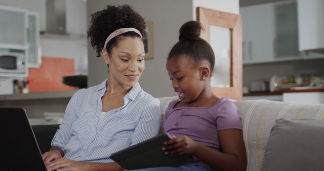 Mother and Daughter Enjoying Time Together on Digital Devices at Home - Download Free Stock Images Pikwizard.com