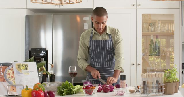 Young Man Preparing Meal in Modern Kitchen with Fresh Ingredients - Download Free Stock Images Pikwizard.com