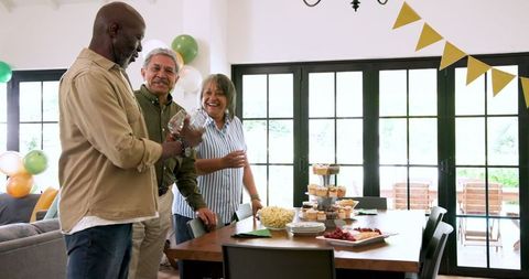 Senior friends setting table for retirement celebration