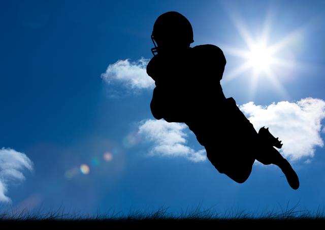 A dynamic image capturing the silhouette of a rugby player leaping mid-air against a clear blue sky with the sun shining brightly. Ideal for use in sports promotions, advertisements, fitness campaigns, or inspirational athletic posters.