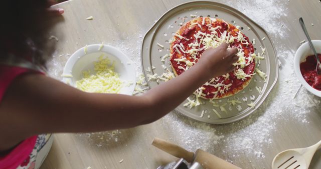Child Making Homemade Pizza Topping with Cheese - Download Free Stock Images Pikwizard.com