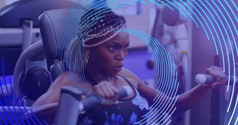 African american woman focused on gym workout with digital effect