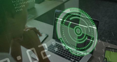 Cybersecurity analyst coding with green holographic hud overlay on laptop workspace