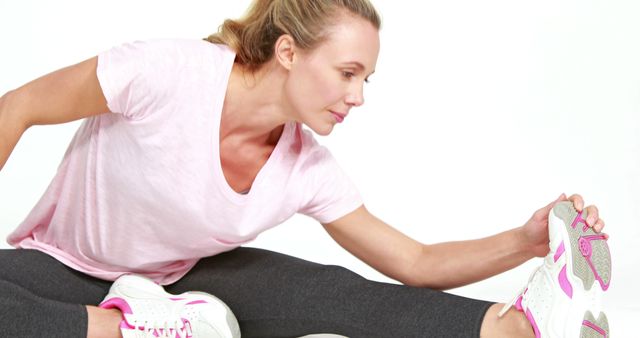 Woman Stretching Legs in Workout Clothing - Download Free Stock Images Pikwizard.com