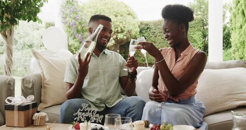 Couple Celebrating Anniversary with Champagne Toast Outdoors