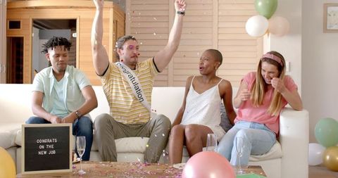 Friends celebrating new job with confetti and joy