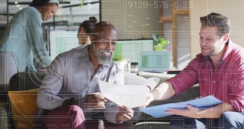 Colleagues analyzing reports in modern tech office environment