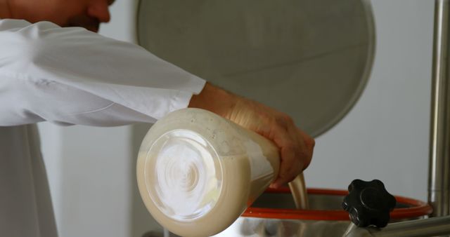 Person Pouring Liquid into Brewing Equipment in Brewery - Download Free Stock Images Pikwizard.com