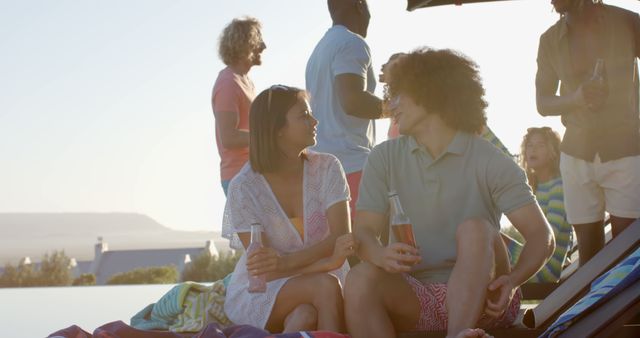 Friends Relaxing with Drinks by Poolside at Sunset - Download Free Stock Images Pikwizard.com