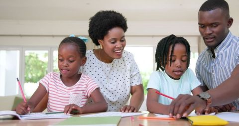 Parents Assisting Daughters With Homework at Home