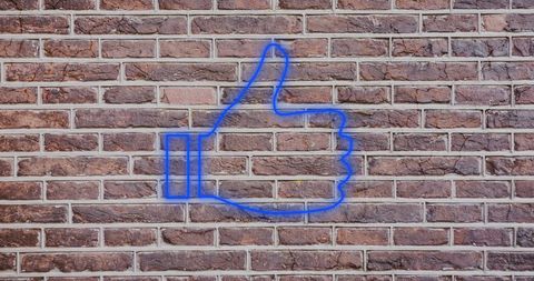 Blue Neon Thumbs Up Symbol Against Brick Wall - Download Free Stock Images Pikwizard.com