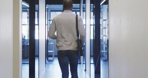 African American Businessman walking in Modern Office Corridor