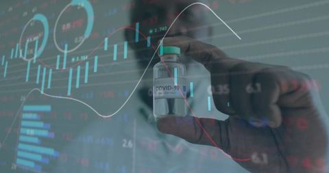 Scientist Analyzing COVID-19 Vaccine amidst Data Charts