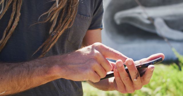 Person with Dreadlocks Using Smartphone Outdoors - Download Free Stock Images Pikwizard.com