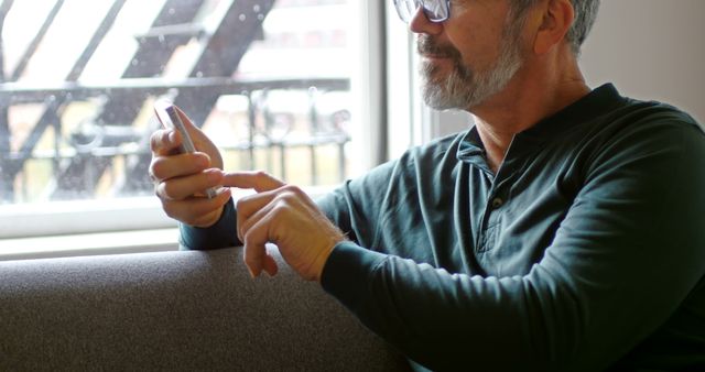 Man with Glasses Using Smartphone in Modern Interior - Download Free Stock Images Pikwizard.com