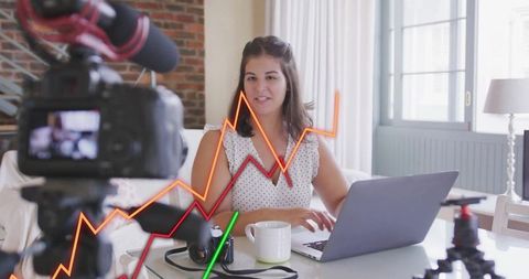 Content creator filming vlog at creative home workspace