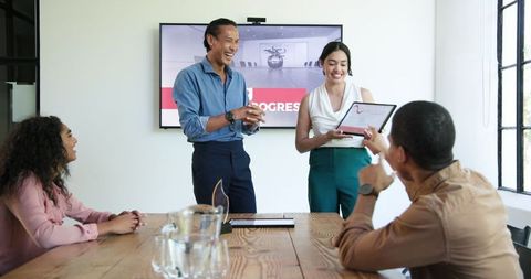 Diverse Team Discussing and Celebrating in Modern Office Space