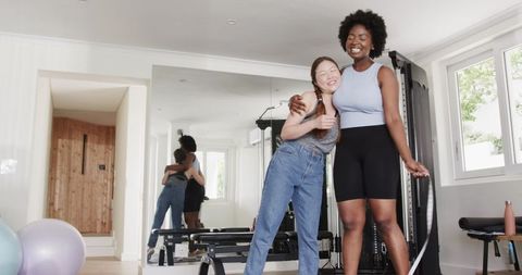 Diverse Female Friends Celebrating Fitness Achievement at Home Gym