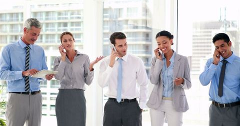 Diverse Professionals Using Mobile Phones in Modern Office - Download Free Stock Images Pikwizard.com
