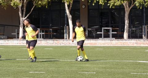 Soccer players perfecting dribbling skills on a sunny field