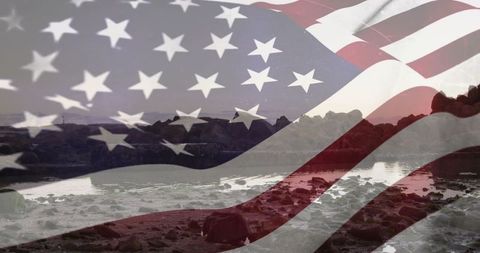American flag blending with rocky shoreline at dawn