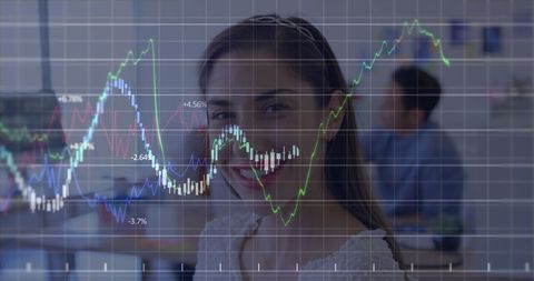 Businesswoman Analyzing Growth Charts with Colleagues in Modern Workspace