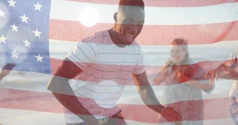 African american man dancing on beach celebrating fourth of july with us flag overlay